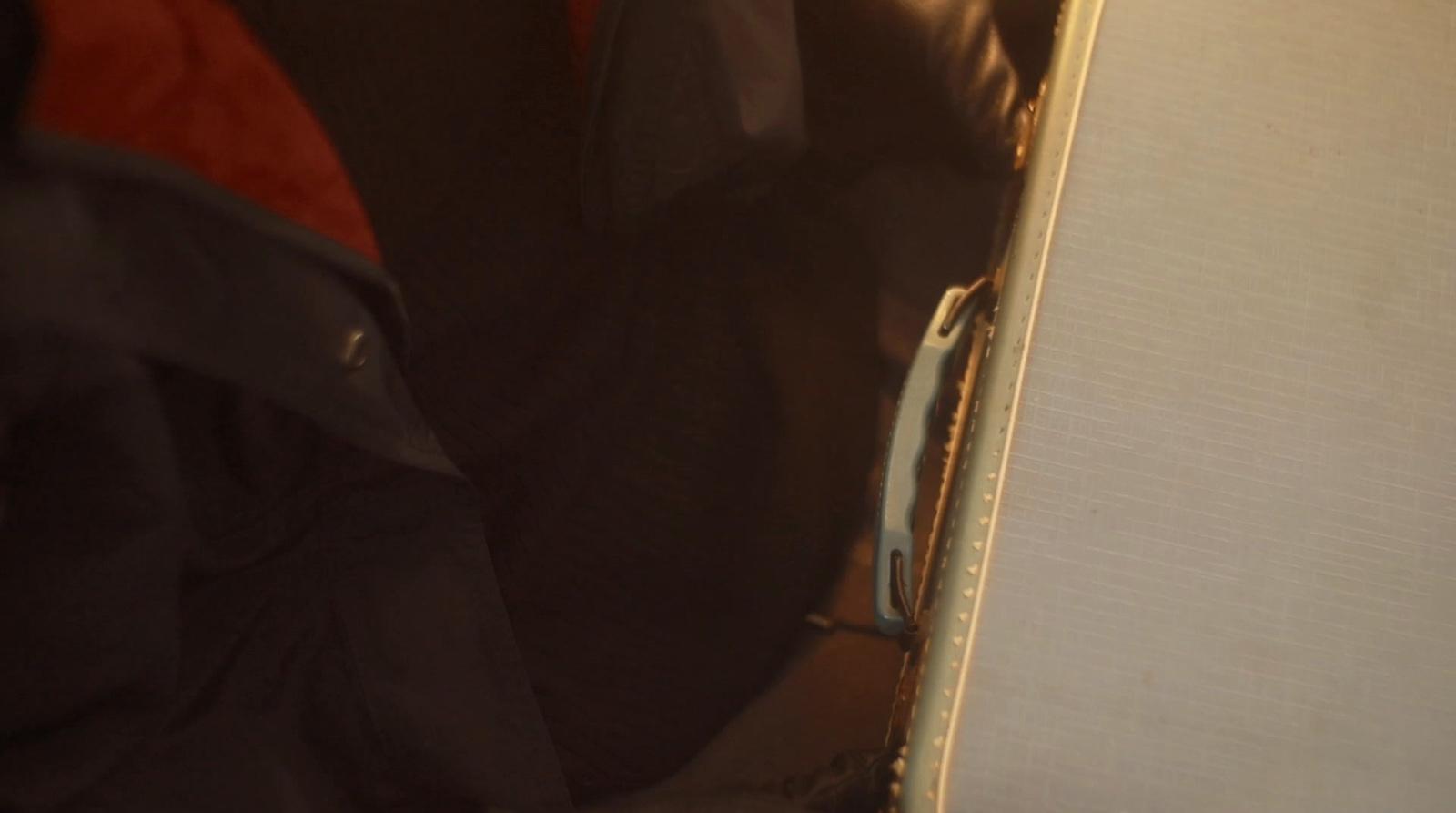 a close up of a suit case with a red tie