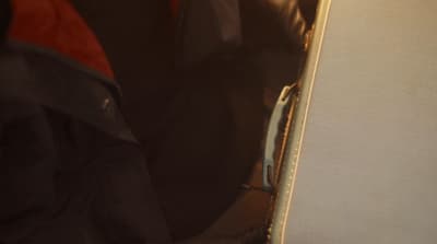 a close up of a suit case with a red tie