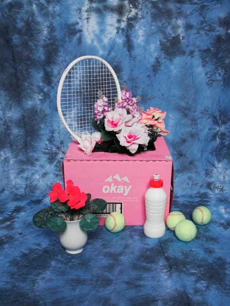 a pink box with flowers and a tennis racket