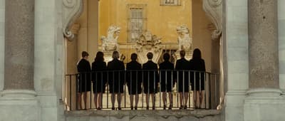 a group of people standing on top of a balcony