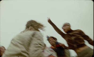 a blurry photo of a person jumping in the air with a frisbee