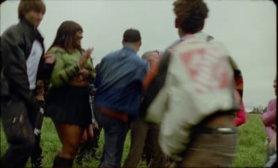 a group of people standing around each other