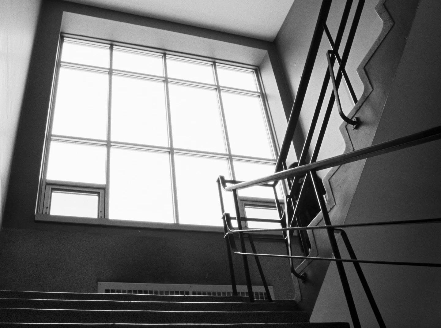 black and white photograph of stairs and windows
