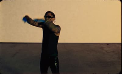 a man in black shirt throwing a blue frisbee