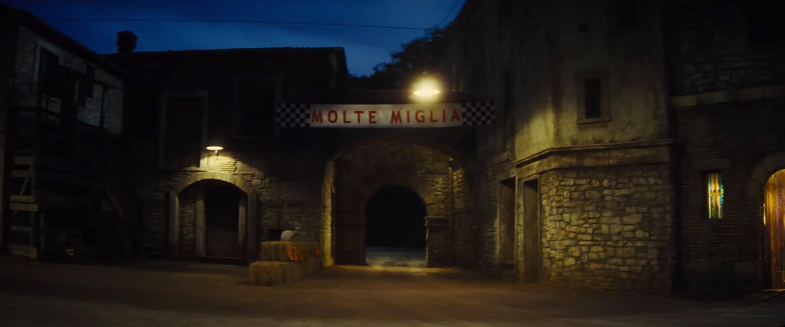 a night time photo of a stone building with a sign that reads hotel night