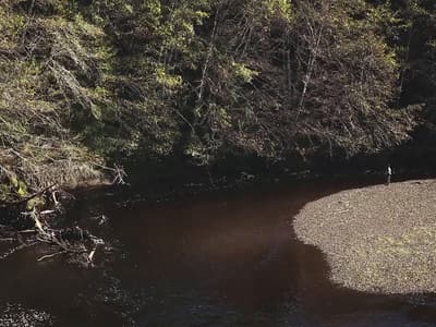 a man standing in the middle of a river