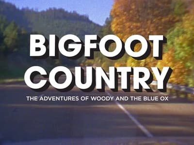 a bigfoot country movie title with trees in the background