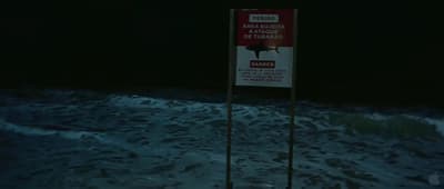 a sign in the middle of a body of water