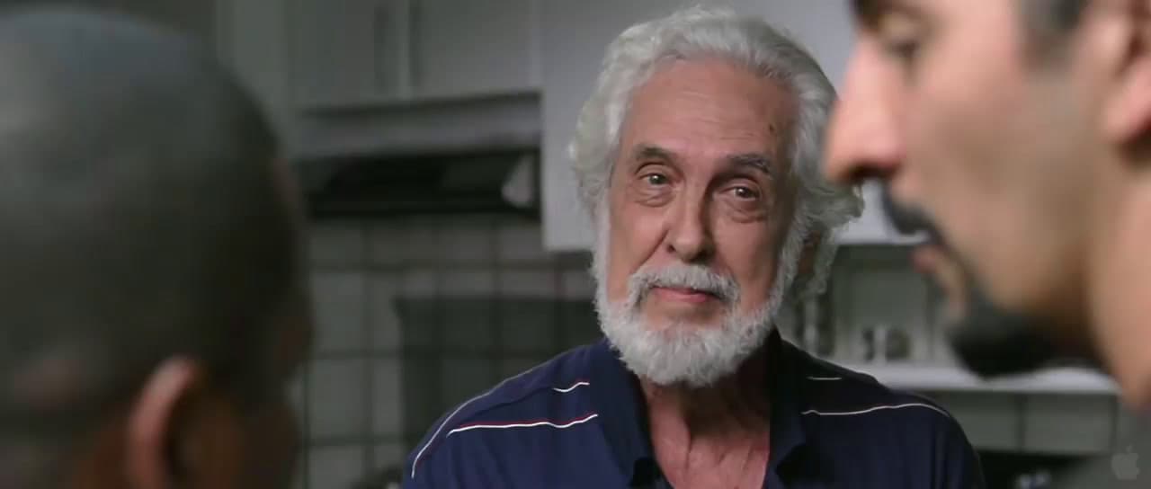 a man with a white beard is talking to another man