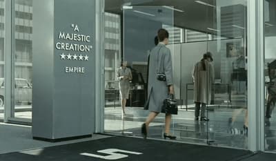 a woman is walking out of a building