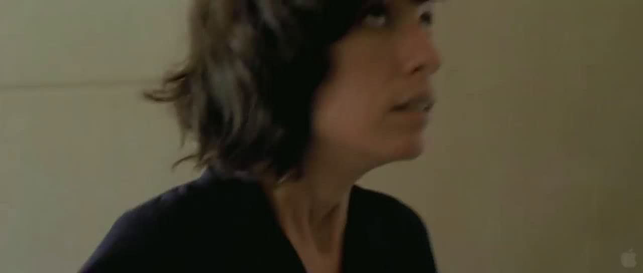 a woman in a black shirt is brushing her teeth