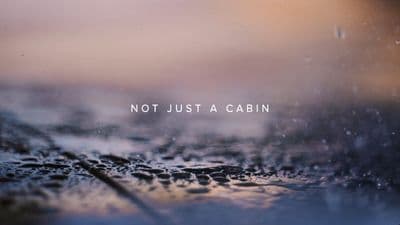 a blurry photo of a wet surface with the words not just a cabin