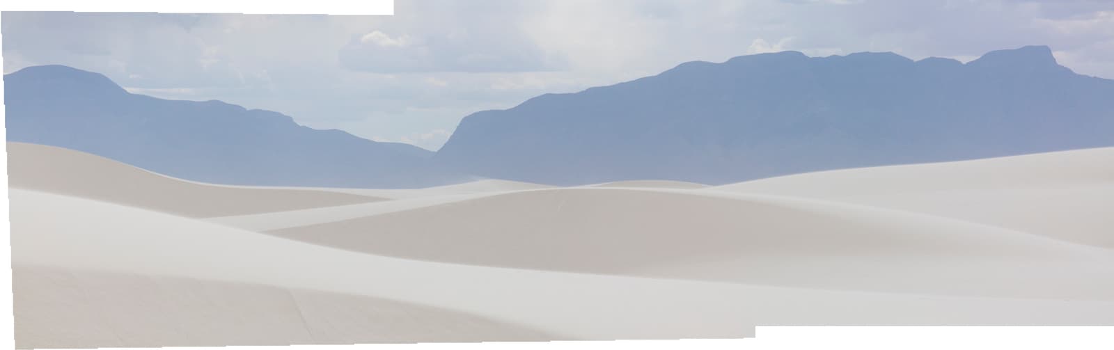 a desert landscape with mountains in the background