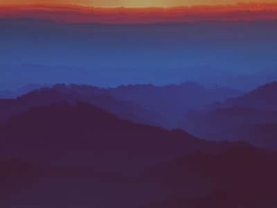 a view of a mountain range at sunset