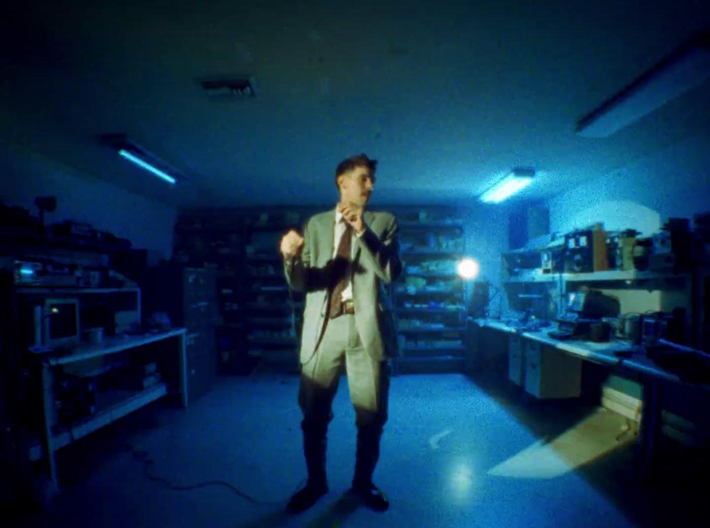 a man in a suit and tie standing in a room