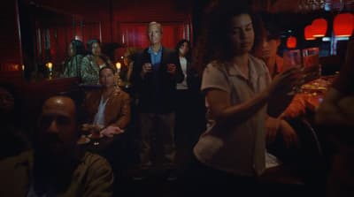 a group of people standing around a bar
