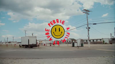 a yellow smiley face sign on the side of a road