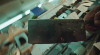 a person holding a piece of metal in their hand