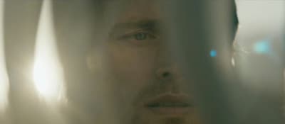 a close up of a person behind a curtain