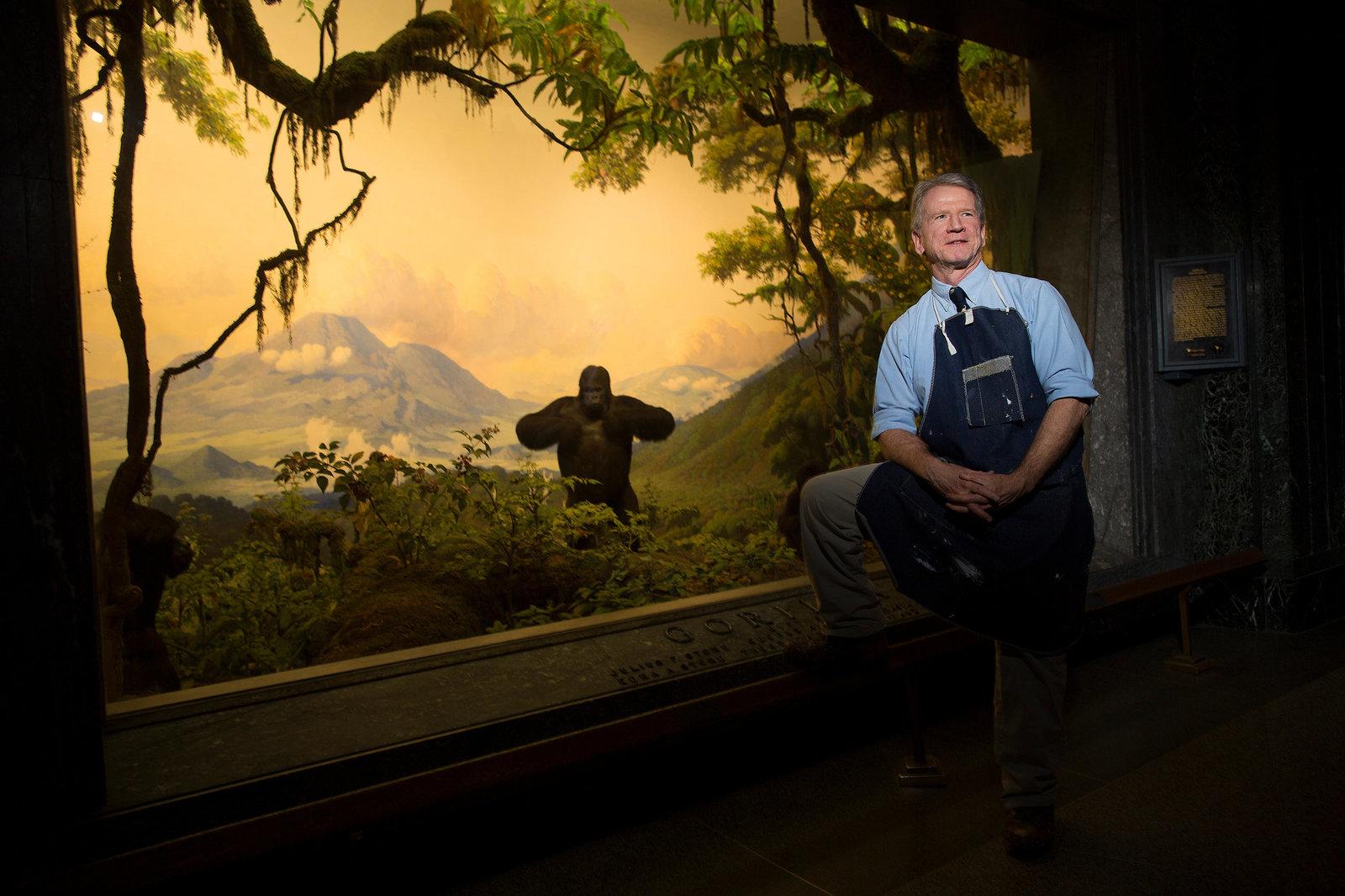 a man sitting on a bench in front of a painting