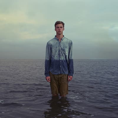 a man standing in the middle of a body of water