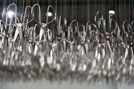 a bunch of scissors hanging from a ceiling