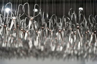 a bunch of scissors hanging from a ceiling