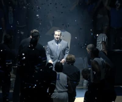 a man in a suit and tie surrounded by confetti
