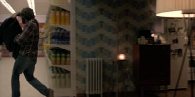 a man is walking through a store with a backpack