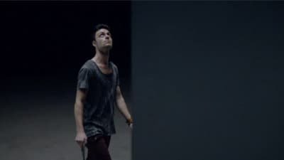 a man standing in a dark room looking up