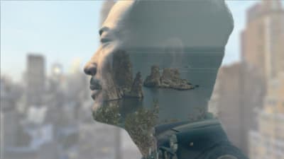 a man looking out of a window at a body of water