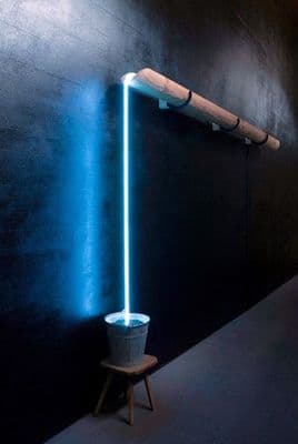 a black wall with a blue light coming out of it