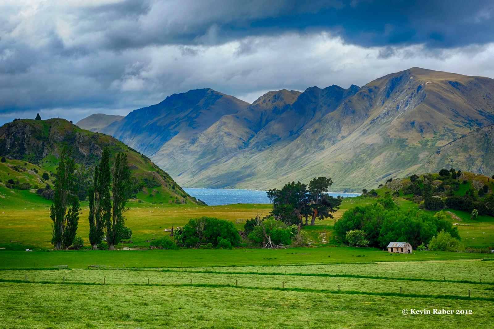 a green field with mountains in the background