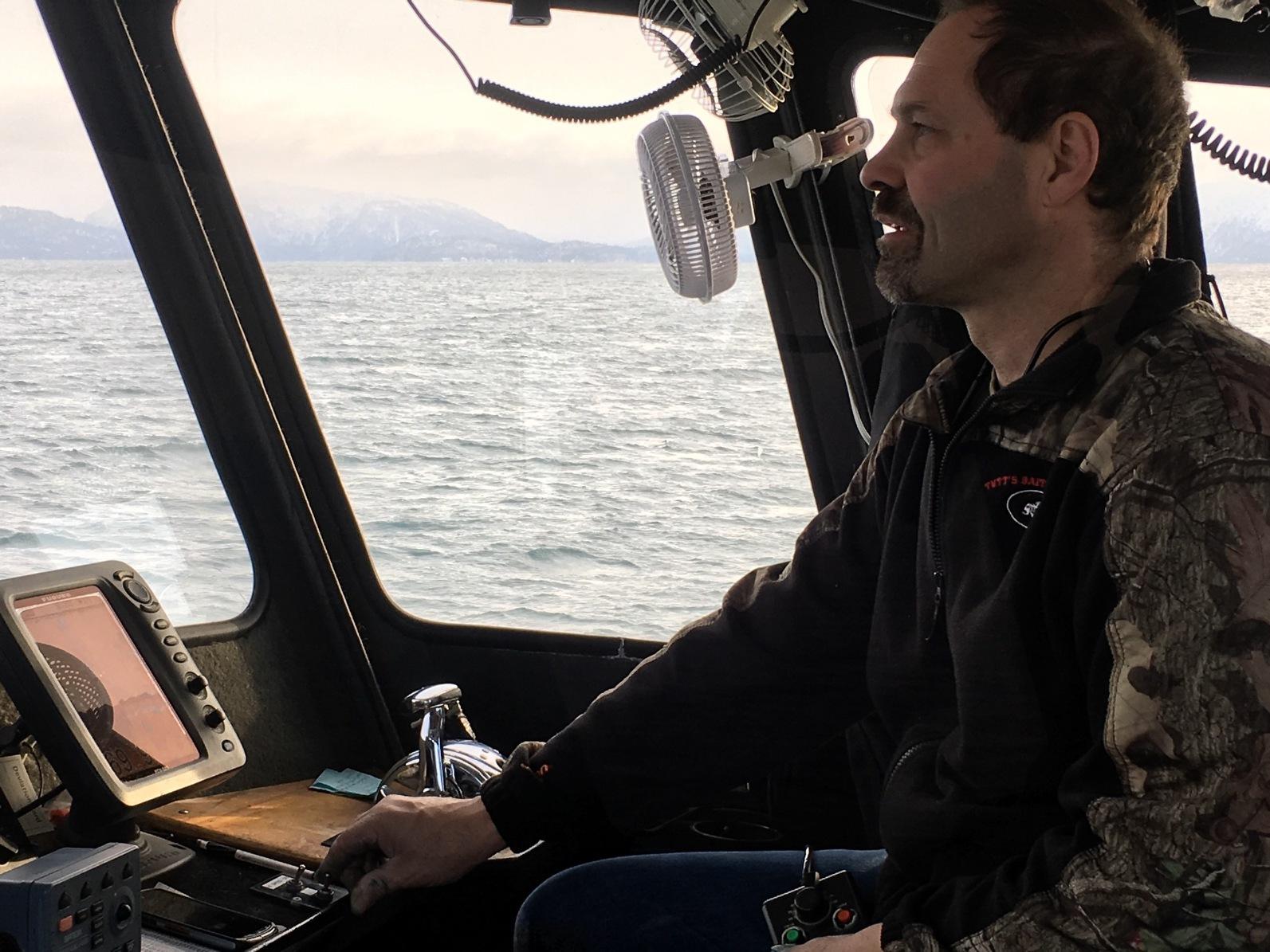 a man sitting in a boat on the water
