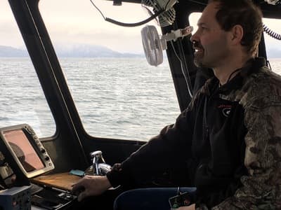 a man sitting in a boat on the water