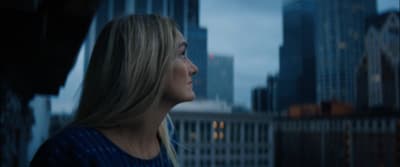 a woman standing in front of a city skyline