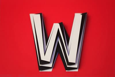 a close up of the letter w on a red background