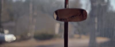 a reflection of a man's face in a mirror
