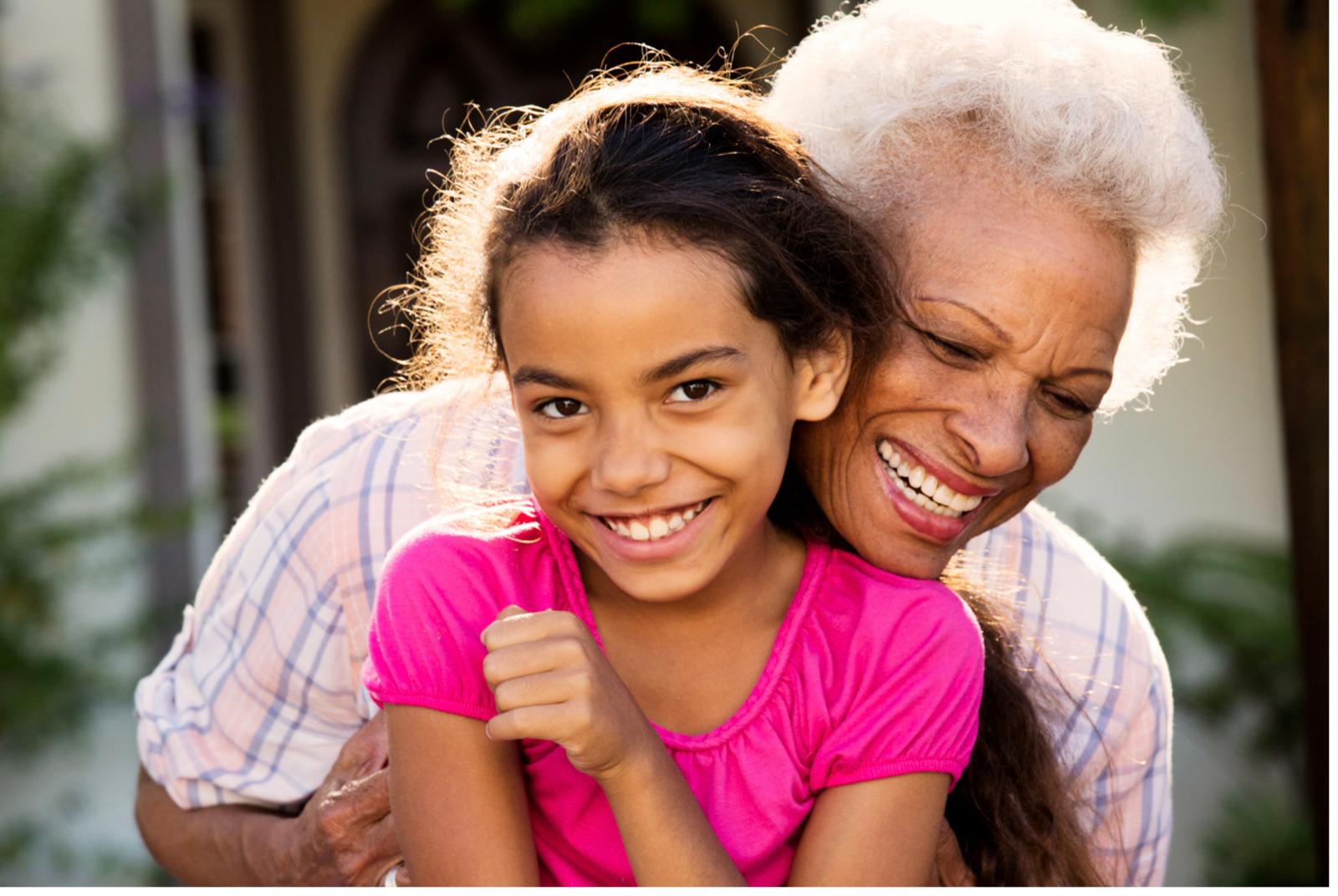an older woman hugging a young girl