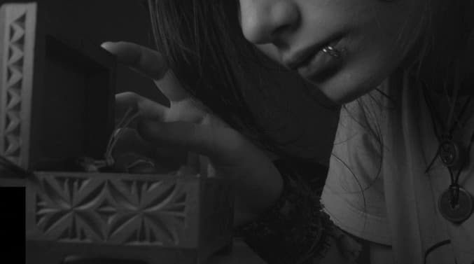 a woman holding a small box in her hands
