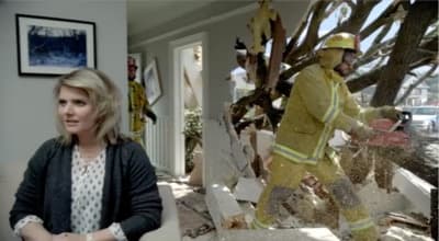 a woman standing in front of a fireman statue