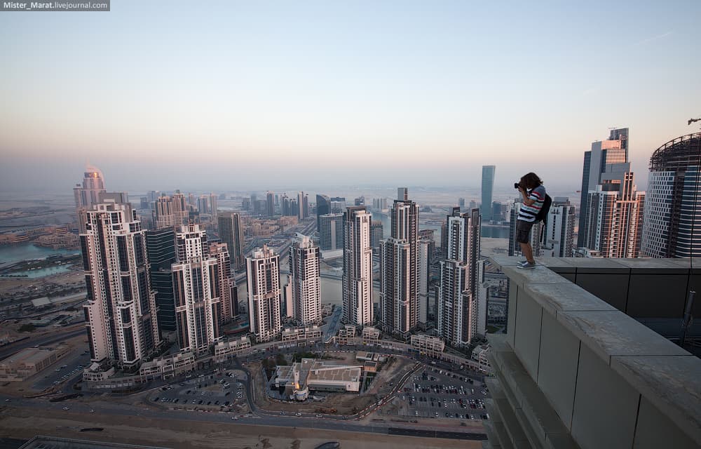 a man standing on top of a tall building