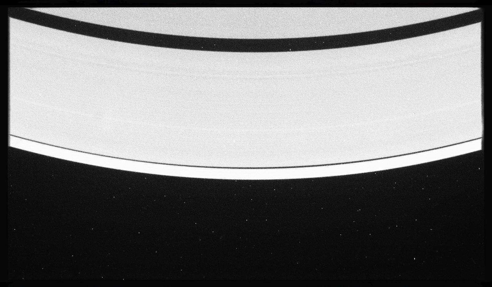 a black and white photo of saturn taken from space