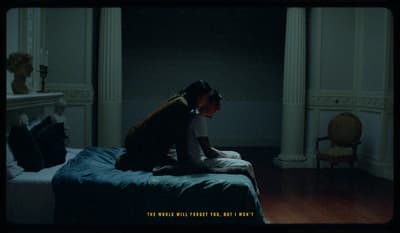 a person sitting on a bed in a room