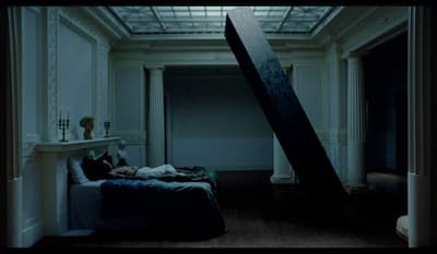 a person laying on a bed in a room