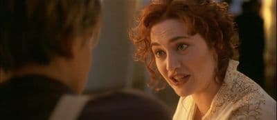 a woman talking to another woman in a room