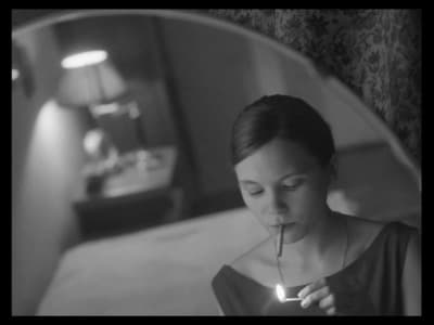 a woman holding a lit candle in her mouth