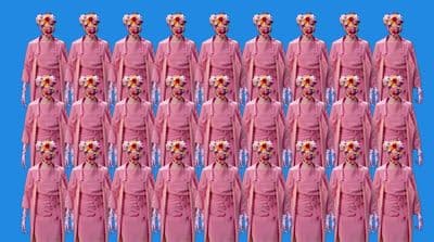 a large group of women in pink dresses