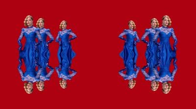 a couple of mannequins dressed in blue dresses