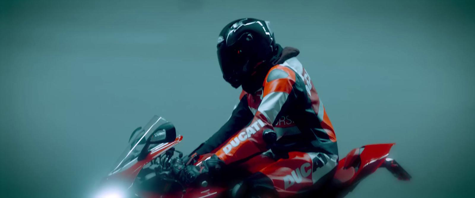 a person riding a motorcycle on a foggy day